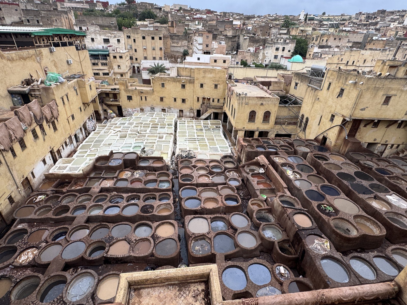 Traditional tanning vats and surrounding buildings at Chouara Tannery in Fes Medina